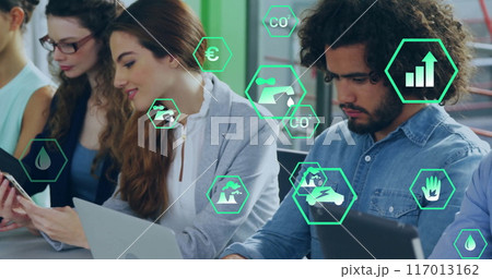 Image of ecology icons over diverse colleagues using technology in office Image of ecology icons over diverse colleagues using technology in office 117013162