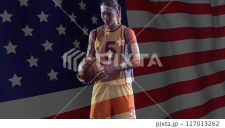 Image of flag of usa over caucasian female basketball player Image of flag of usa over caucasian female basketball player 117013262