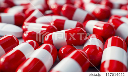 Red white pills or capsules freely laid on a table. 117014022