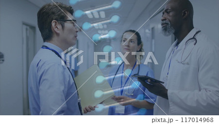 Image of dna strand over diverse doctors working in hospital Image of dna strand over diverse doctors working in hospital 117014968