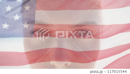 Image of american flag over portrait close up of caucasian woman in sunshine opening eyes 117015544