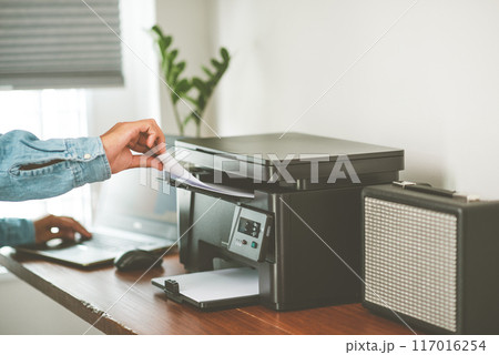 The man using the laser printer. 117016254