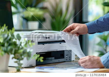 Businessman in Corporate Office Using Multifunction Laser Printer to Print Important Documents Concept Highlighting Ink and Toner Supplies in Professional Setting 117016464