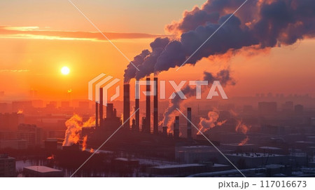 A large industrial plant is spewing smoke into the air 117016673