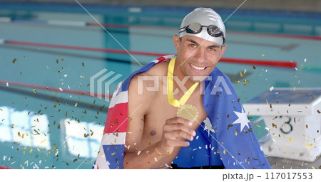 Image of confetti over biracial male swimmer holding medal with flag of australia Image of confetti over biracial male swimmer holding medal with flag of australia 117017553