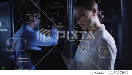 Working on laptop, woman with code snippets over data center background Working on laptop, woman with code snippets over data center background 117017665