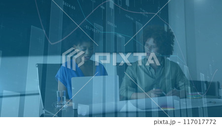 Financial data charts image over business meeting with two people discussing Financial data charts image over business meeting with two people discussing 117017772