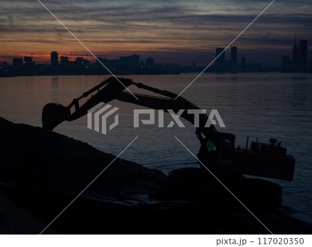 Excavator work at night. Overtime work. The work of construction equipment on the seashore. Batumi. Fortified shores. Excavator work at night. Overtime work. The work of construction equipment on the seashore. Batumi. Fortified shores. 117020350