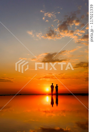 Silhouettes of people against sky seascape sunset sky on sea or ocean 117021339
