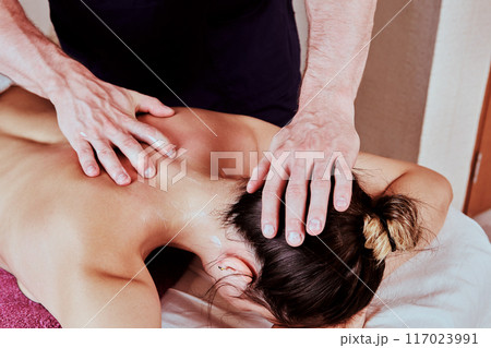 Massage therapy for back and neck pain for young women 26 years old. Massage therapy for back and neck pain for young women 26 years old. 117023991
