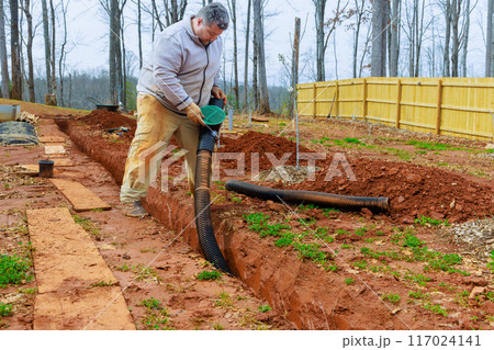 Installation storm drainage drain pipes in trench drains for drainage of rain water 117024141