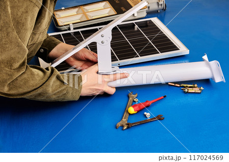 Solar panel and LED light are prepared for installation on mounting bracket, DIY street lighting assembly. Solar panel and LED light are prepared for installation on mounting bracket, DIY street lighting assembly. 117024569