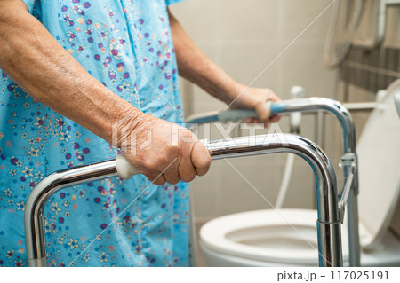 Asian elderly woman patient use walker and toilet bathroom handle security in nursing hospital, healthy strong medical. 117025191