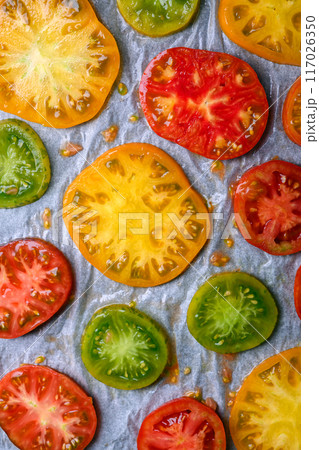 Tomato slices of different types and colors before baking Tomato slices of different types and colors before baking 117026350