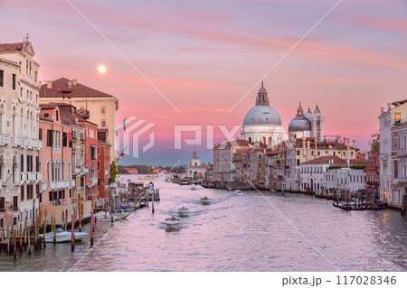 Pink sunset sky over the Grand Canal in Venice at sunset. Pink sunset sky over the Grand Canal in Venice at sunset. 117028346