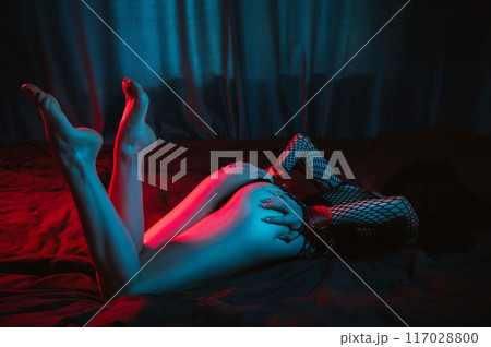 submissive woman with sexy body and ass with hands in BDSM handcuffs lies on bed in bedroom. Slave girl in lingerie for sex with submission and domination submissive woman with sexy body and ass with hands in BDSM handcuffs lies on bed in bedroom. Slave girl in lingerie for sex with submission and domination 117028800