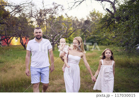 family of four on a walk in the park family of four on a walk in the park 117030015