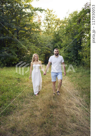a 30-year-old couple in love in the garden a 30-year-old couple in love in the garden 117030053