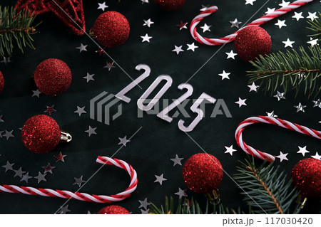New Year 2025 dark background. Number of the coming year in Christmas decoration. 117030420