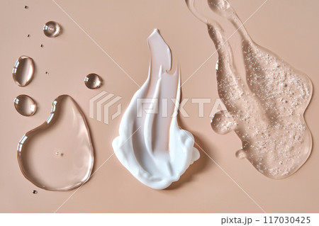 Three cosmetic products on a beige background.  117030425