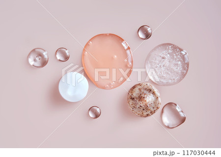 Several cosmetic products on a pink background.  117030444
