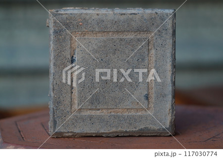 Square paving slabs stand on the side. Building materials for landscaping, improvement of living spaces in the urban environment Square paving slabs stand on the side. Building materials for landscaping, improvement of living spaces in the urban environment 117030774