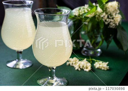 Carbonated elderflower drink. Flower summer kvass in glasses Carbonated elderflower drink. Flower summer kvass in glasses 117030898