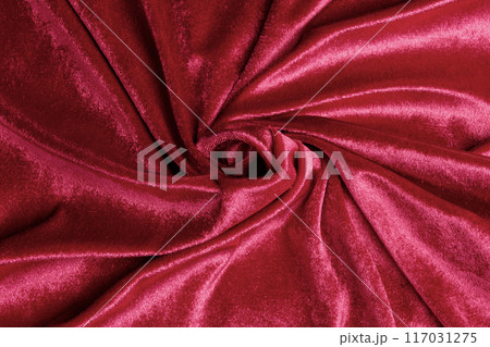 Textured background of deep red velvet fabric with folds. Textured background of deep red velvet fabric with folds. 117031275