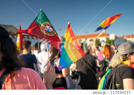 LGBTQ person holding flags of Portugal and rainbow 117034137