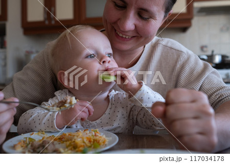 Mother feeding child. Healthy nutrition for children.  117034178