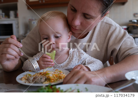 Mother feeding child. Healthy nutrition for children.  117034179