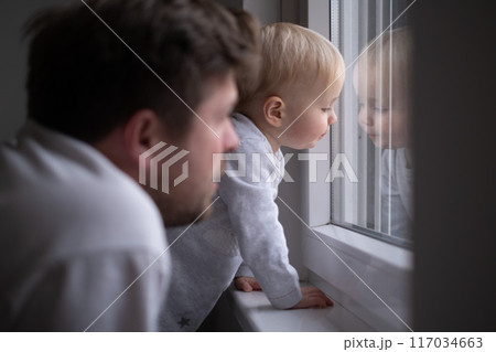 Father with toddler girl daughter looking into window Father with toddler girl daughter looking into window 117034663