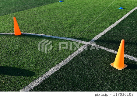 artificial green grass soccer field with orange training cones artificial green grass soccer field with orange training cones 117036108