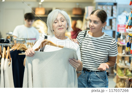 Ladies carefully select sweaters 117037266