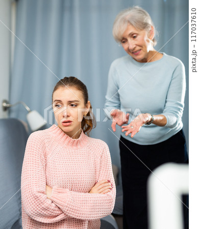 Mother encouraging her depressed adult daughter 117037610