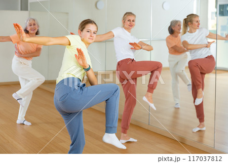 Girl dancing with her relatives during group training 117037812