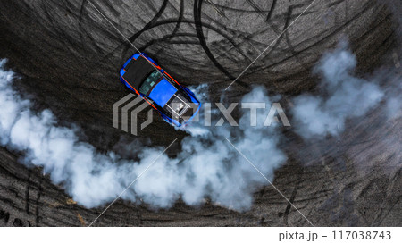 Aerial top view car drifting diffusion race drift car with lots of smoke from burning tires on speed track, Professional driver drifting car with lots of white smoke. 117038743