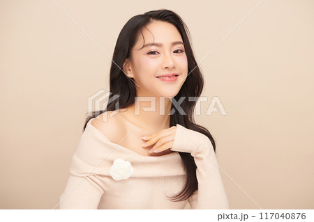 Beautiful young asian woman with clean fresh skin on beige background, Face care, Facial treatment, Cosmetology, beauty and spa, Asian women portrait. 117040876