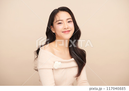 Beautiful young asian woman with clean fresh skin on beige background, Face care, Facial treatment, Cosmetology, beauty and spa, Asian women portrait. Beautiful young asian woman with clean fresh skin on beige background, Face care, Facial treatment, Cosmetology, beauty and spa, Asian women portrait. 117040885