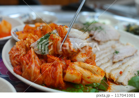 Korean traditional food with thinly sliced boiled pork and freshly made cabbage kimchi 117041001