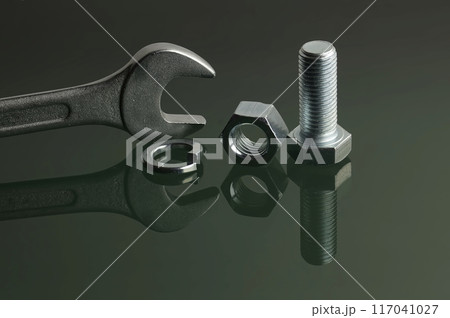 Wrench and mechanical fasteners on reflective surface 117041027