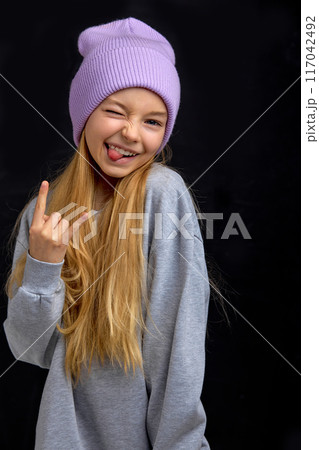 beautiful funny girl stick out her tongue. 117042492