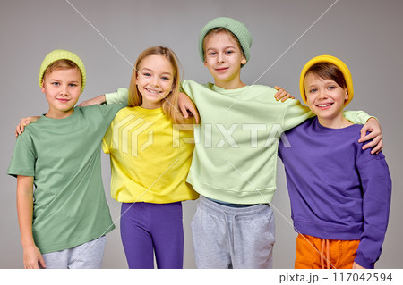 cheerful happy kids holding hands on shoulders looking at camera cheerful happy kids holding hands on shoulders looking at camera 117042594
