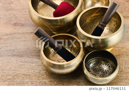 Tibetan Singing Bowls on a wooden surface Tibetan Singing Bowls on a wooden surface 117046131