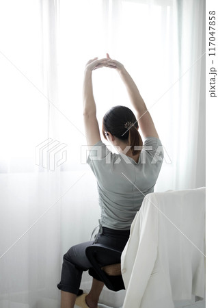 Woman having back body pain during work long time. stretching to relax and relax while working hard at the office Woman having back body pain during work long time. stretching to relax and relax while working hard at the office 117047858