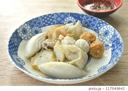 dry boiled meatball made from fish and shrimp dressing fried garlic in oil on plate dipping spicy and sour sauce 117049642