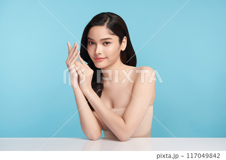 Beautiful Young transgender woman with clean fresh skin on blue background, Face care, Facial treatment, Cosmetology, beauty and spa, transgender women portrait. Beautiful Young transgender woman with clean fresh skin on blue background, Face care, Facial treatment, Cosmetology, beauty and spa, transgender women portrait. 117049842