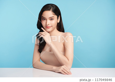 Beautiful Young transgender woman with clean fresh skin on blue background, Face care, Facial treatment, Cosmetology, beauty and spa, transgender women portrait. Beautiful Young transgender woman with clean fresh skin on blue background, Face care, Facial treatment, Cosmetology, beauty and spa, transgender women portrait. 117049846