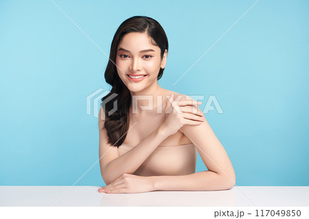 Beautiful Young transgender woman with clean fresh skin on blue background, Face care, Facial treatment, Cosmetology, beauty and spa, transgender women portrait. Beautiful Young transgender woman with clean fresh skin on blue background, Face care, Facial treatment, Cosmetology, beauty and spa, transgender women portrait. 117049850