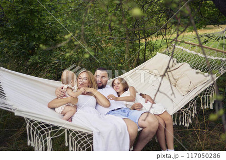 family mother father sister teenager and baby in hammock 117050286